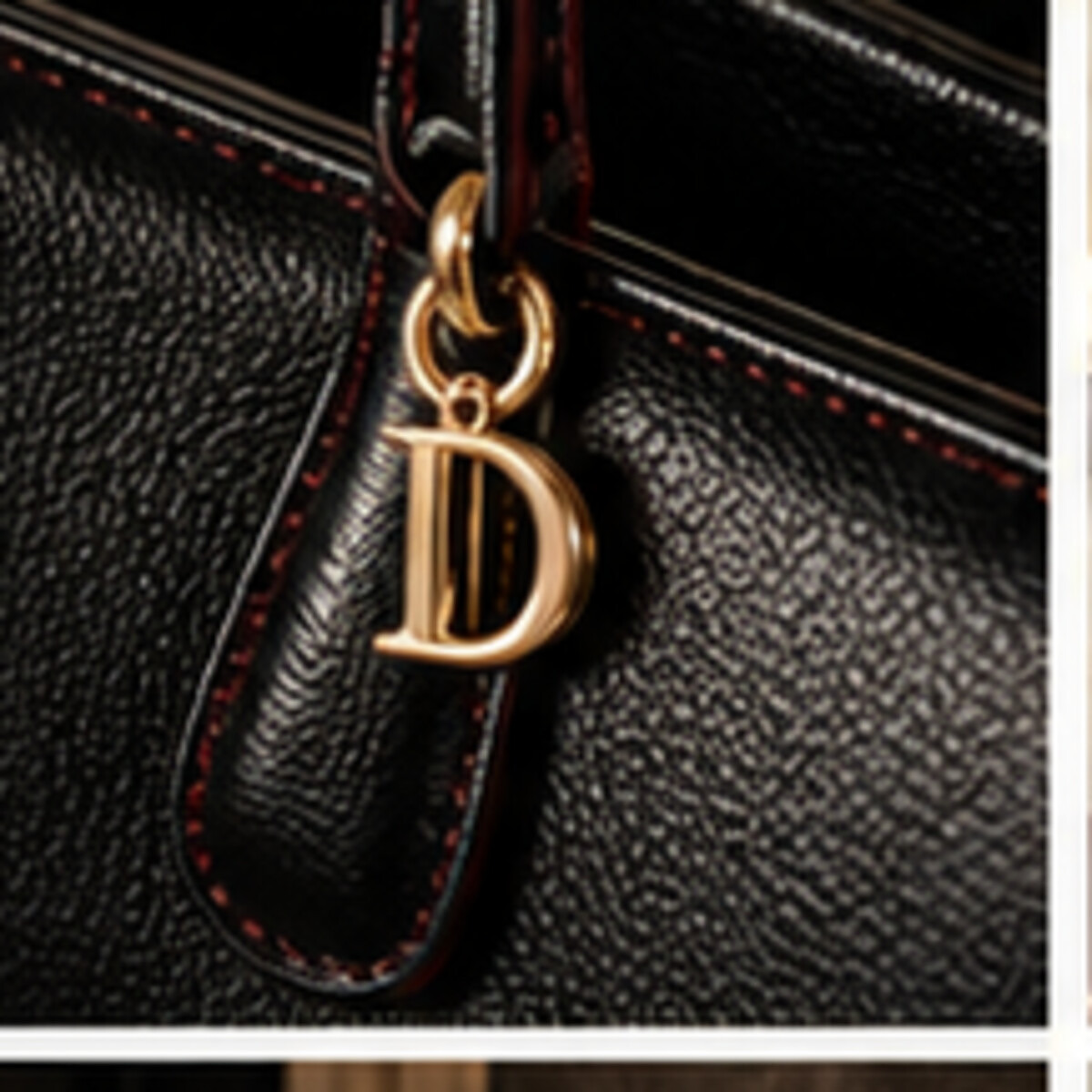 Close-up DEMETER goddess hardware on black leather